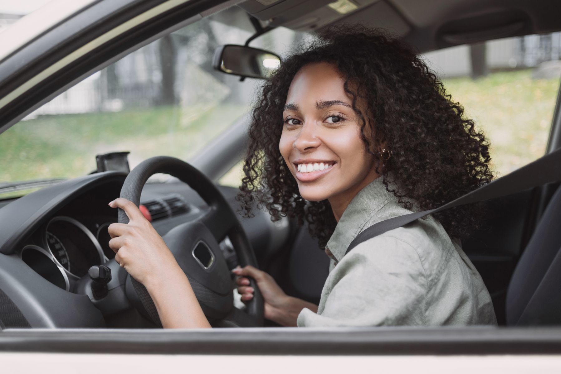 Happy woman driving a car
